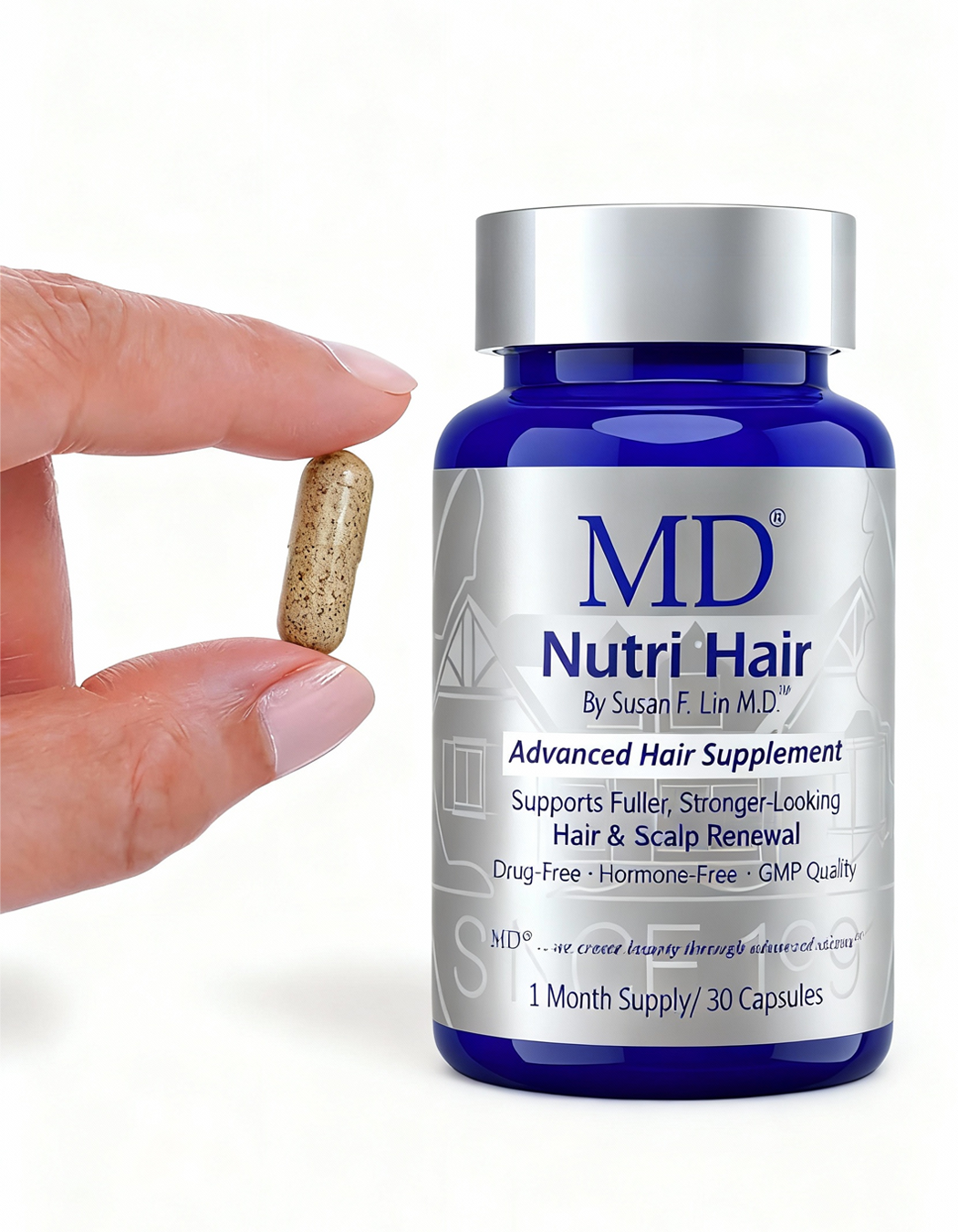 Lifesize hand holding one MD Nutri Hair capsule next to the bottle to show easy-to-swallow size. Physician-formulated hair density support