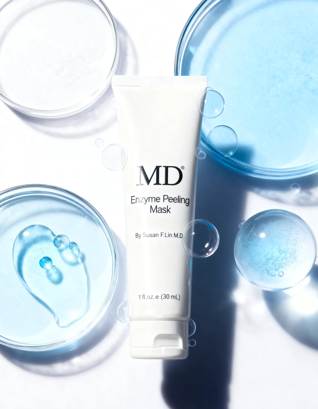 MD® Enzyme Peeling Mask shown with fresh papaya fruit to highlight the natural Papain enzymes that dissolve dead skin cells