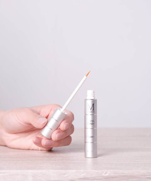 Close-up of MD Lash Factor 3-Month applicator tip showing clear, lightweight lash growth serum consistency for precise application